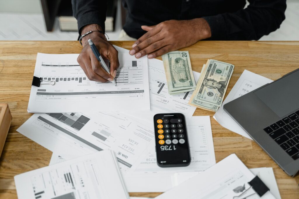 Finance and accounting outsourcing professional reviewing tax calculations and financial reports at their desk