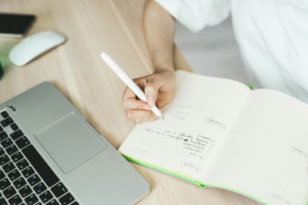 Marketing professional hired via an SEO recruitment agency writing SEO strategy notes during a work session