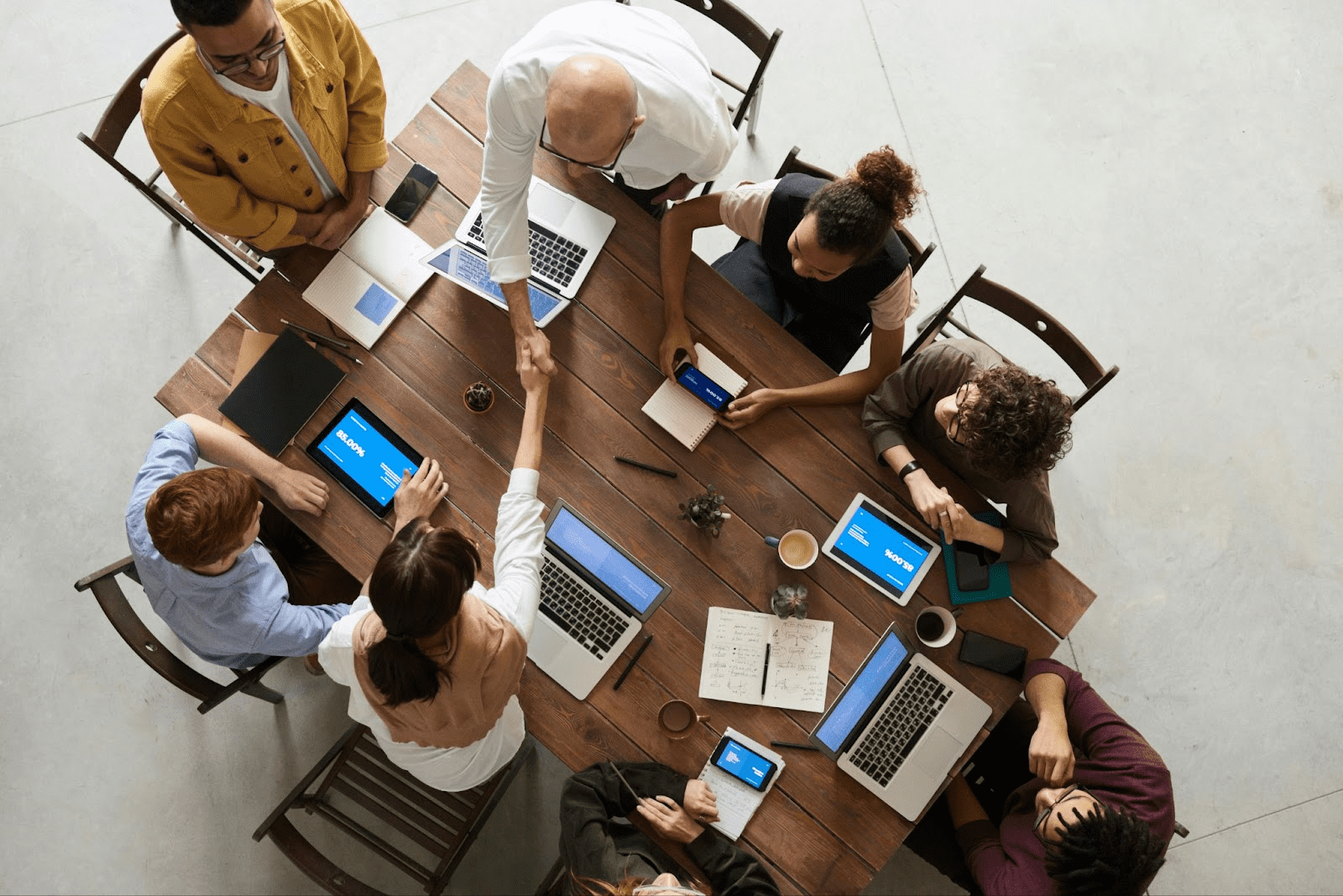 Professionals in a boardroom discussing hiring strategies with nearshore staffing companies.