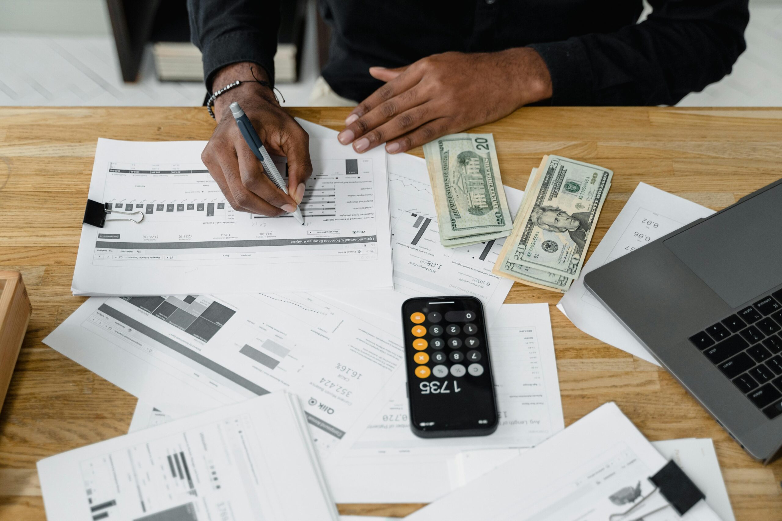 Finance and accounting outsourcing professional reviewing tax calculations and financial reports at their desk