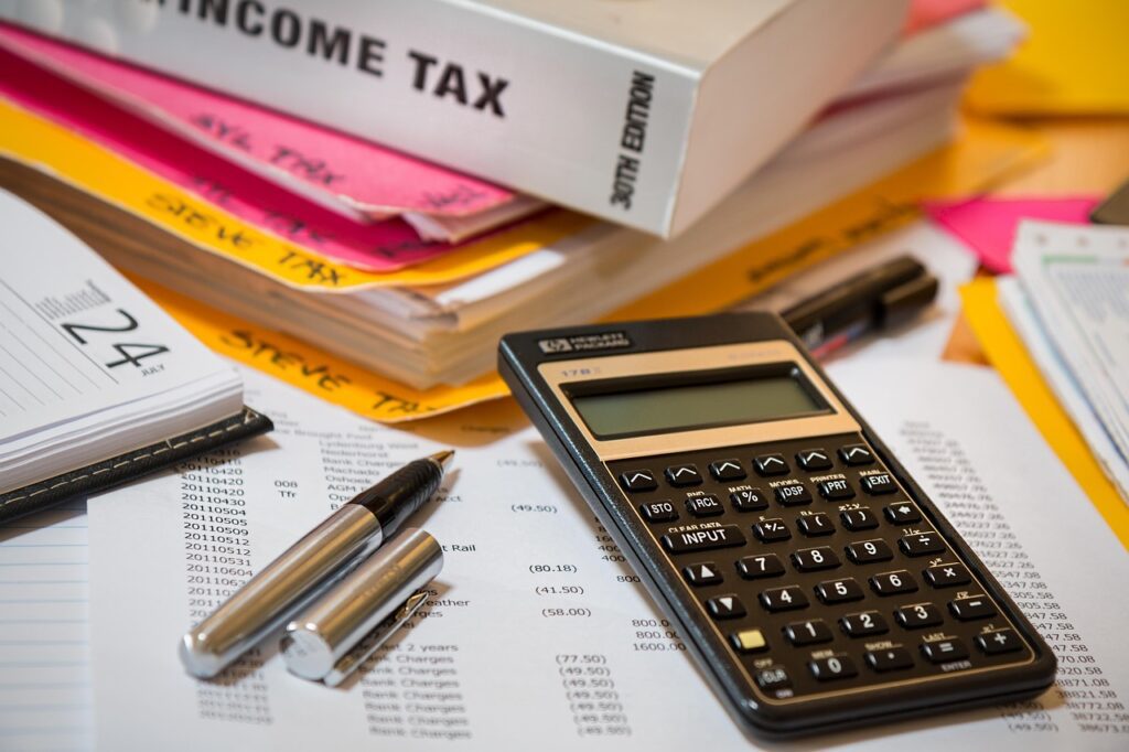 Close-up of a calculator and financial documents on a desk, representing finance recruitment and accounting analysis.