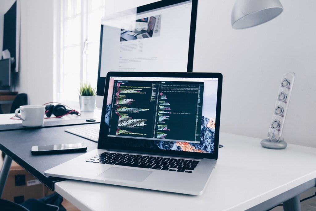 Laptop displaying software development code, representing offshore development companies and global tech talent solutions in 2025.
