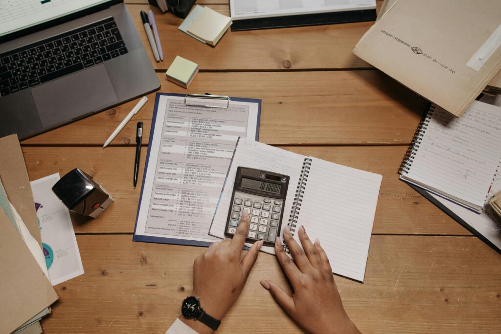 Accounting professional reviewing financial statements with calculator, illustrating offshore staffing for accounting firms
