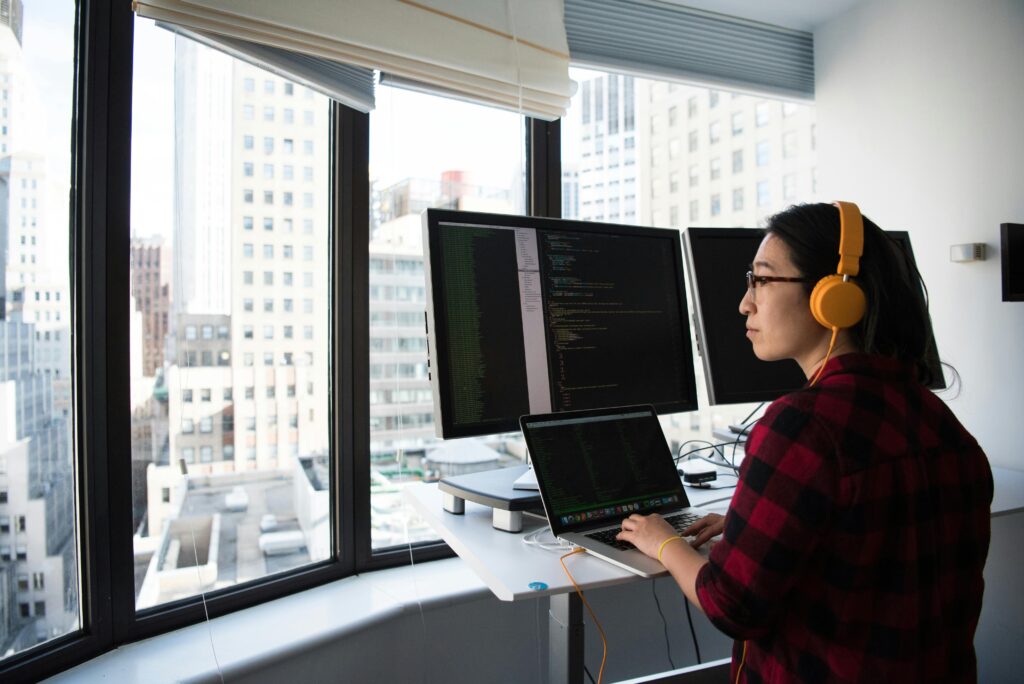 Remote engineer working on multiple technical screens, illustrating engineering recruitment agencies sourcing top engineering talent.
