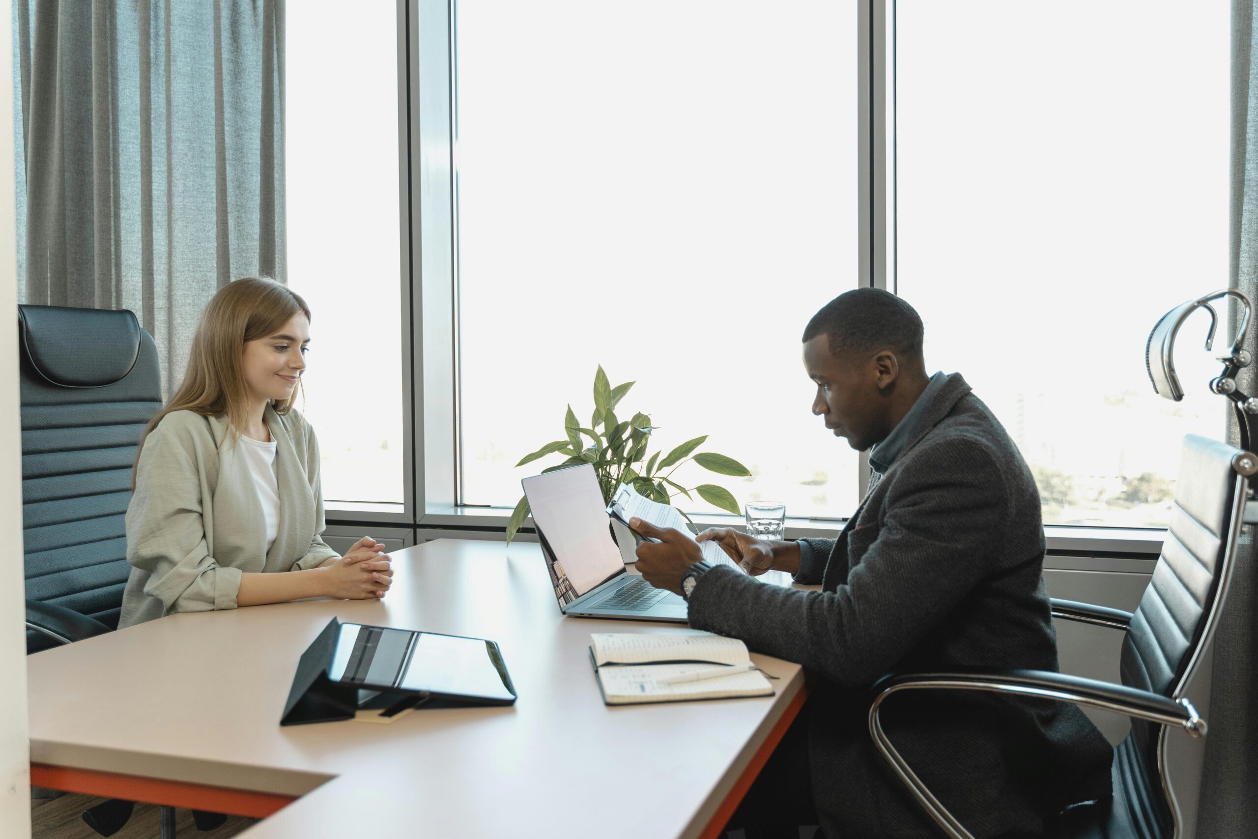 Hiring manager conducting interview with international candidate during recruitment meeting