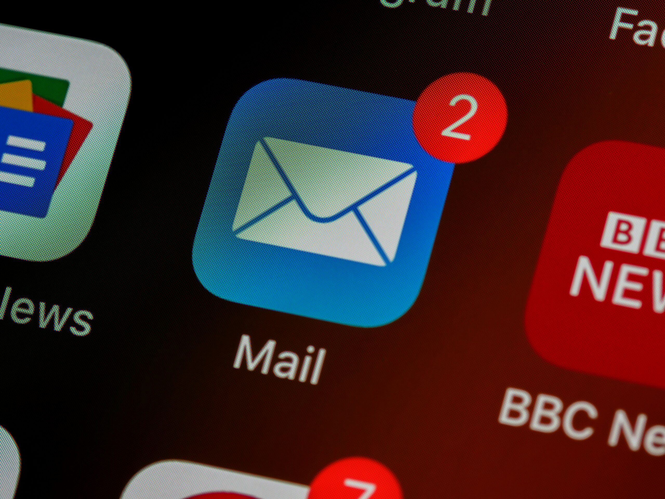 Mailchimp alternatives illustrated by an email app icon with unread message notifications on a smartphone.
